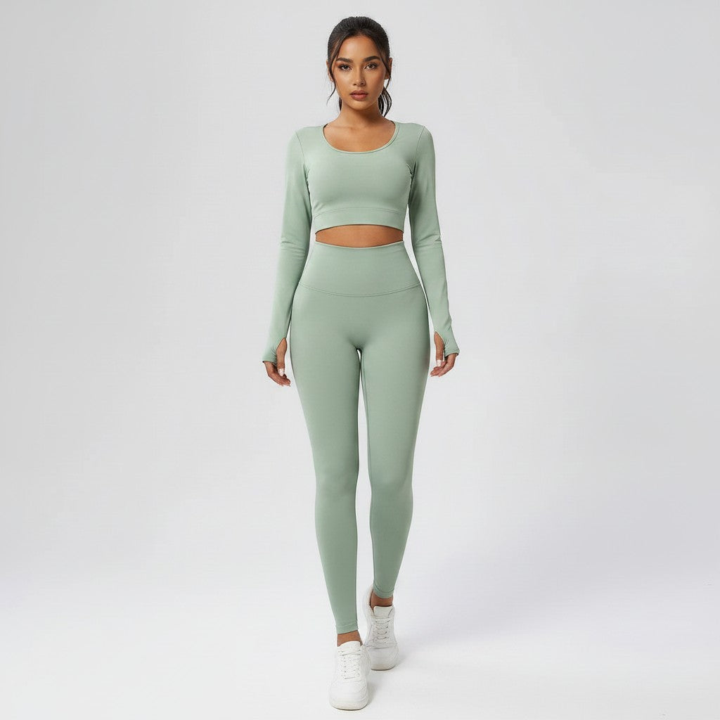 A model wearing VIVU sage green seamless high-waist leggings and a matching long-sleeve crop top for activewear.